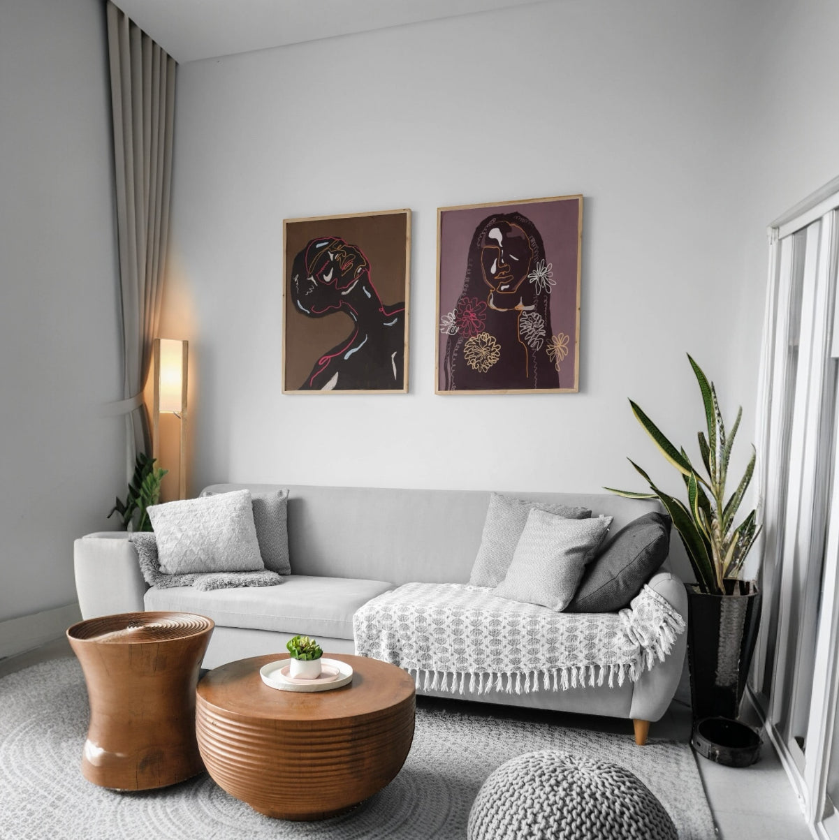 Framed floral-inspired line art of women, displayed in a cozy living room setting.