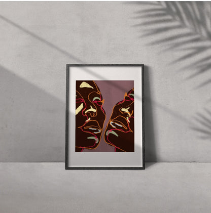 Framed artwork of two abstract faces on a gray wall
